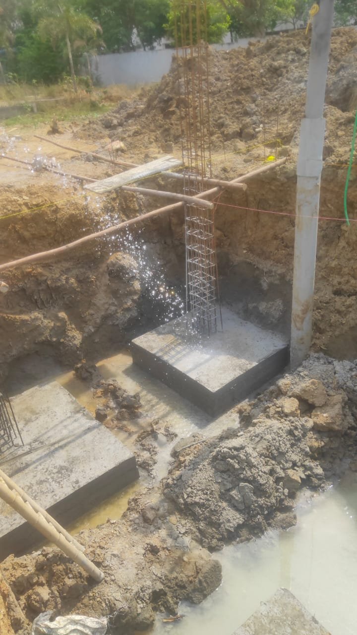 Cement bags and aggregates staged on a Chennai construction site